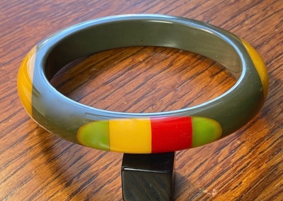 SZ65 Shultz grey bakelite bangle with oval dots in red, yellow, green